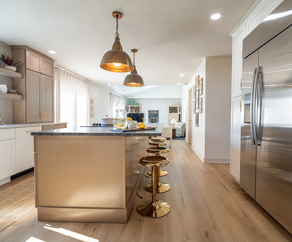 Neutral kitchen featuring warm wood tone LVT plank flooring from Tarkett Home