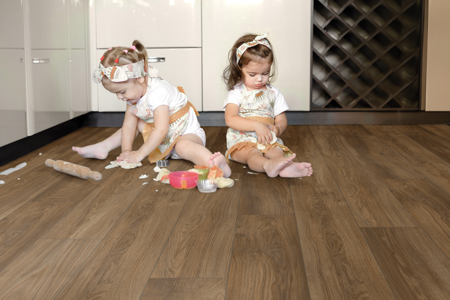 Children playing in kitchen on ShoreFlor™ Waterproof Laminate from Tarkett Home